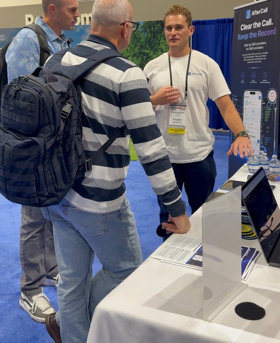Jordan talking with EMS providers at the AfterCall booth at EMS World