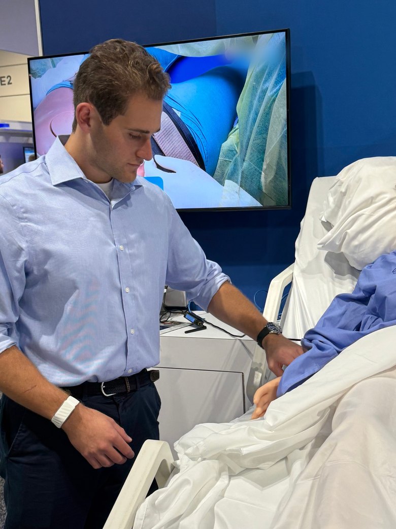 Jordan at a patient bedside training simulator